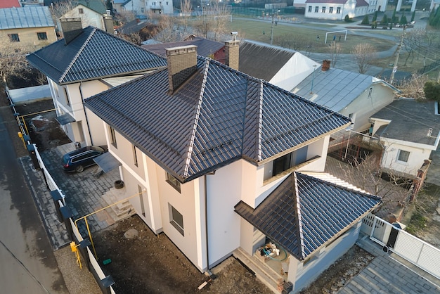 Aerial view of private house with ceramic shingles covered roof top. Investment in real estate concept