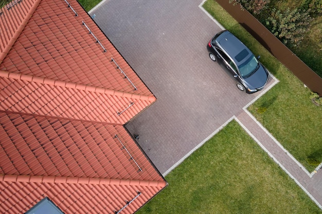 Aerial view of private house with ceramic shingles covered roof top Investment in real estate concept