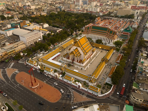 An aerial view of Red Giant Swing and Suthat Thepwararam Temple at sunset scene The most famous tourist attraction in Bangkok Thailand