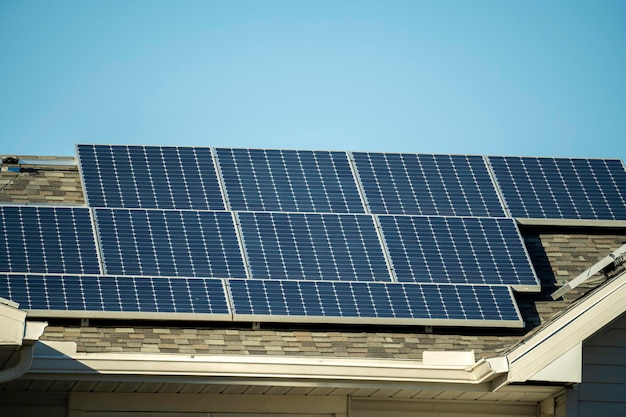 Aerial view of regular american home roof with blue solar photovoltaic panels for producing clean ecological electric energy Renewable electricity with zero emission concept