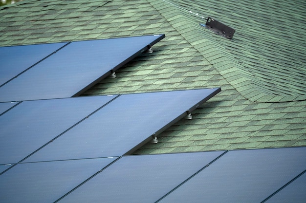 Aerial view of regular american home roof with blue solar photovoltaic panels for producing clean ecological electric energy Renewable electricity with zero emission concept