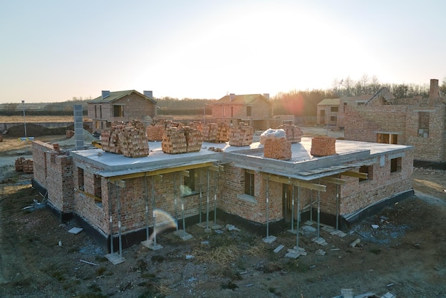 Aerial view of residential houses under construction in rural suburban area Real estate development