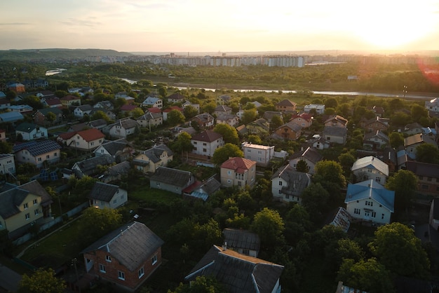 Aerial view of residential houses in suburban rural area at sunset