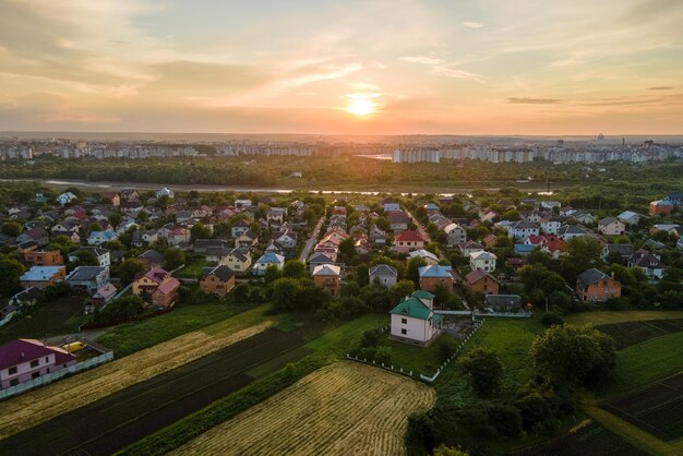 Aerial view of residential houses in suburban rural area at sunset