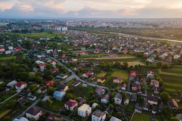 Aerial view of residential houses in suburban rural area at sunset