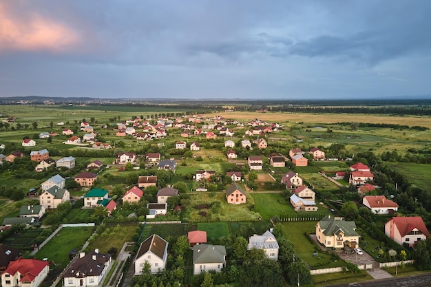 Aerial view of residential houses in suburban rural area at sunset