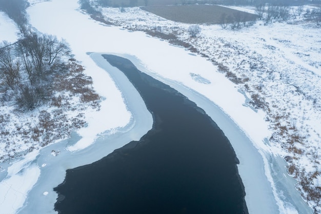 Aerial view of the river covered with ice thaw melting ice on the river