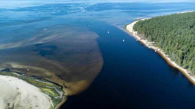 Aerial view the river flows into the bay.Sandy shore, shallow, water transport