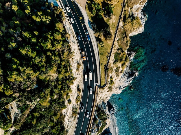 Aerial view of road going along the mountain and ocean or sea Drone photography from above