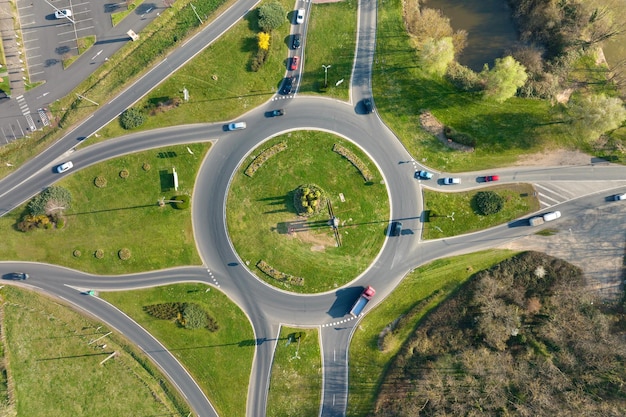 Aerial view of road roundabout intersection with moving heavy traffic Urban circular transportation crossroads