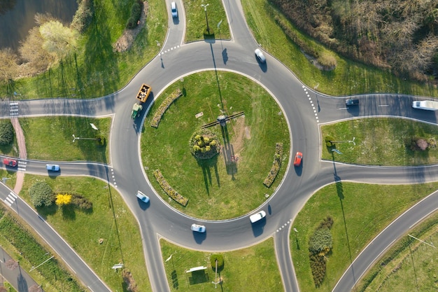 Aerial view of road roundabout intersection with moving heavy traffic Urban circular transportation crossroads