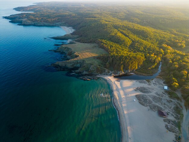 Aerial view of the rocky wild coast of the black sea in bulgaria with cliffs beaches and green