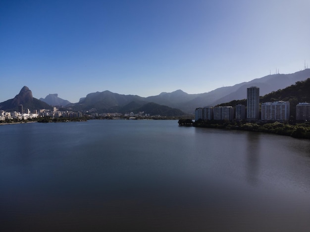 Aerial view of Rodrigo de Freitas Lagoon south zone of Rio de Janeiro Brazil In the background the beaches of Ipanema and Leblon and Morro Dois Irmaos Sunny day Buildings around Drone photo