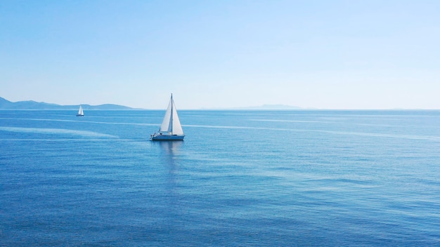 Aerial view of sailing luxury yacht at opened sea at sunny day in croatia