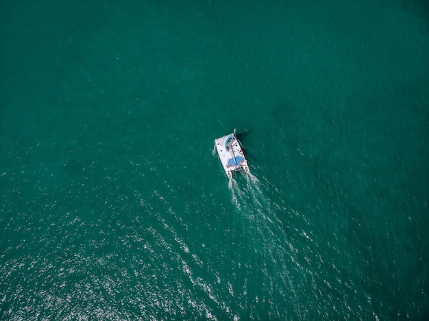 Aerial view of a  sailing yacht in the turquoise water of the Andaman sea. Phuket. Thailand