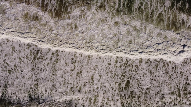 Aerial view of sandy beach and sea waves