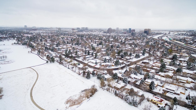 Aerial view of school sport fields and residential area in the Winter.