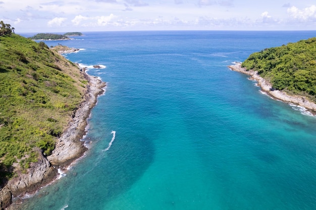 Aerial view of sea crashing waves White foaming waves on sandy shore Top view beach in Phuket Thailand