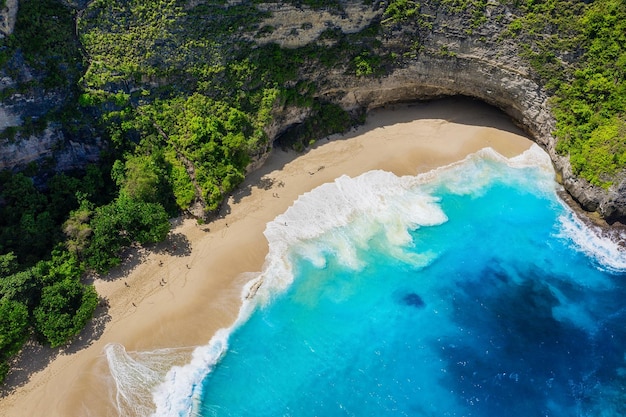 Aerial view on the sea and rocks Turquoise water background from top view Summer seascape from air Kelingking beach Nusa Penida Bali Indonesia Travel image