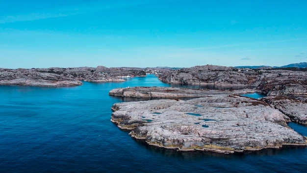 Aerial view of the sea wave and rocks of the coastline of Norway. Panoramic view of the rocks