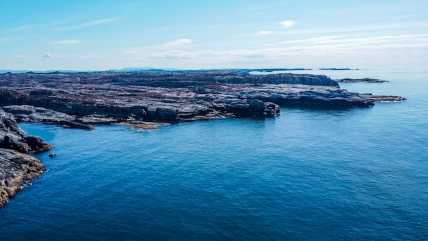 Aerial view of the sea wave and rocks of the coastline of Norway