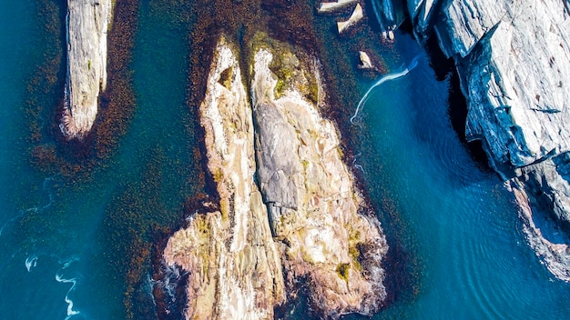 Aerial view of the sea wave and rocks of the coastline of Norway