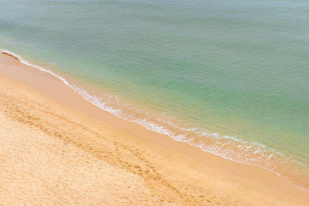 Aerial view of sea waves and sandy beach