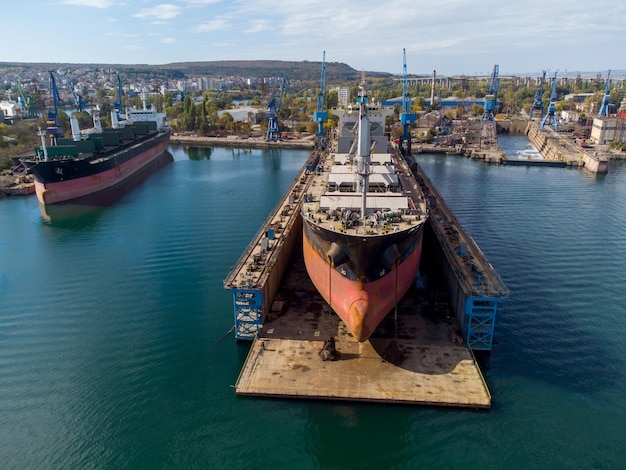 Aerial view shipyard dry dock maintenance and repair cargo ship transport and oil ships in sea