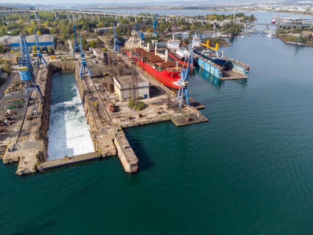 Aerial view shipyard dry dock maintenance and repair cargo ship transport and oil ships in sea