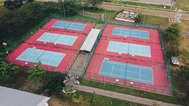 Aerial view of six empty tennis courts