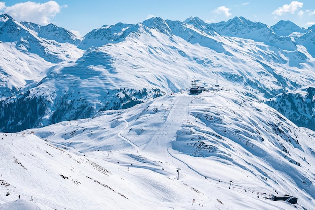 Aerial view of ski lift and skiers on snow covered hill slope