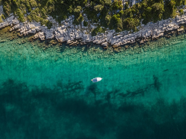 Aerial view of a small sailing boat docked at Otok Zavinac Veli