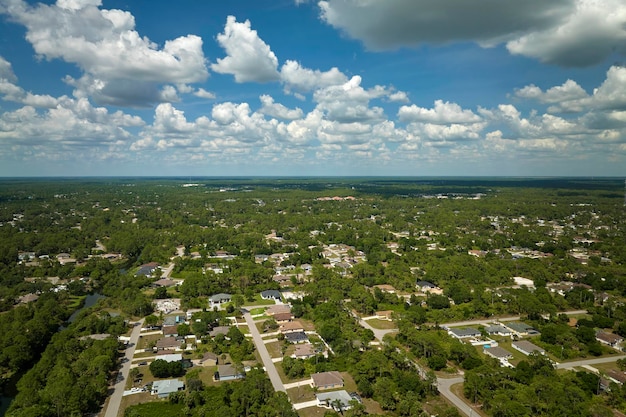 Aerial view of small town America suburban landscape with private homes between green palm trees in Florida quiet residential area