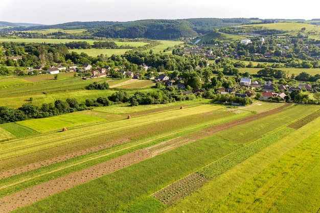 aerial view of a small village win many houses and green agricultural fields