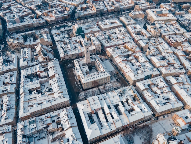 Aerial view of snowed lviv center copy space city blocks directly above