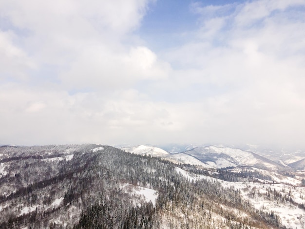 Aerial view of snowed ukrainian carpathian mountains copy space