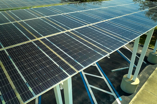 Aerial view of solar panels installed as shade roof over parking lot for parked cars for effective generation of clean electricity Photovoltaic technology integrated in urban infrastructure