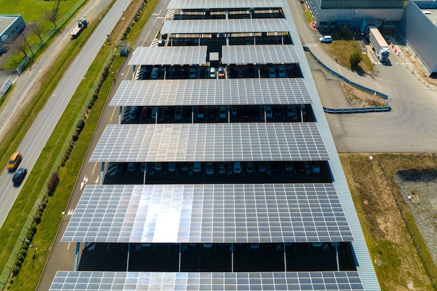 Aerial view of solar panels installed as shade roof over parking lot with parked cars for effective generation of clean electricity Photovoltaic technology integrated in urban infrastructure