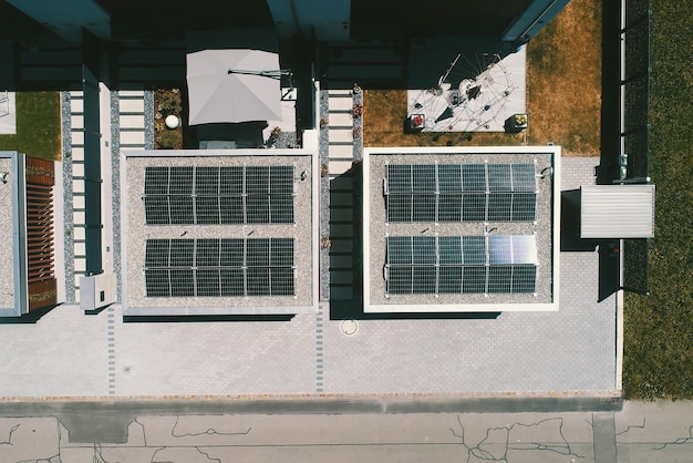 Aerial view of solar panels or solar cells on the roof of house Power plant renewable clean energy source Eco technology for electric power in industry