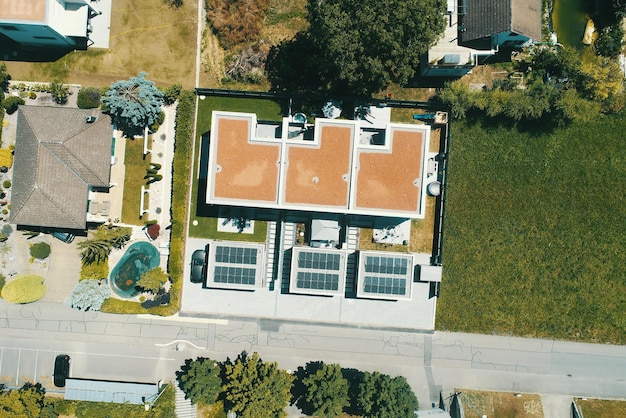 Aerial view of solar panels or solar cells on the roof of house Power plant renewable clean energy source Eco technology for electric power in industry