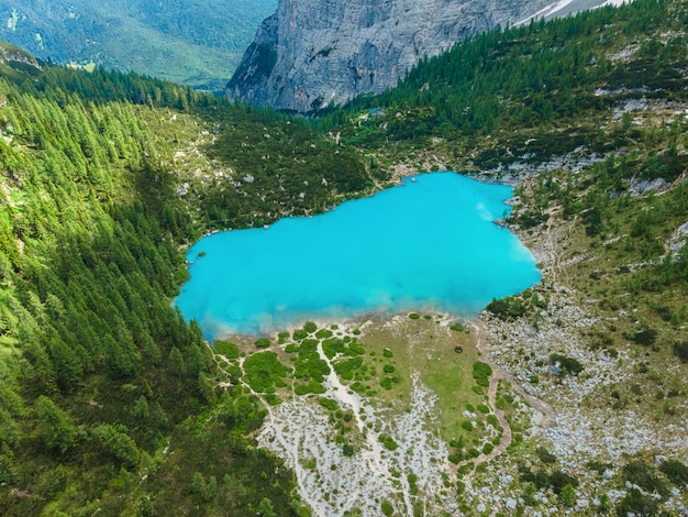 Aerial view of Sorapis Lake in Dolomites mountains, Cortina d'Ampezzo, Italy. Beautiful Alpine lake Lago di Sorapis. Drone shot. Travel destination