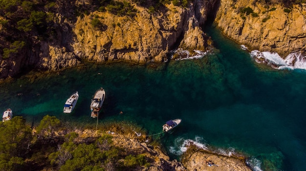 Aerial view of the Spanish coast of a cove with boats