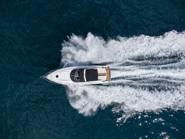 Aerial view of speed motor boat on open blue sea