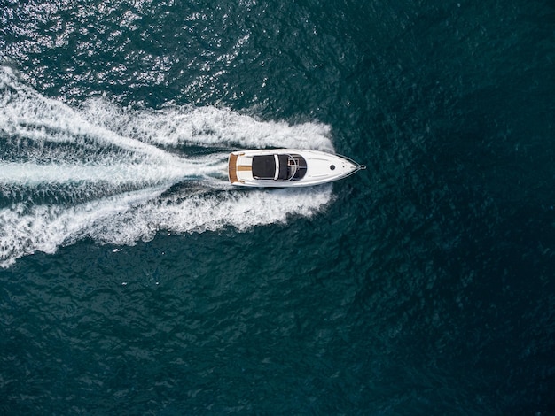 Aerial view of speed motor boat on open blue sea