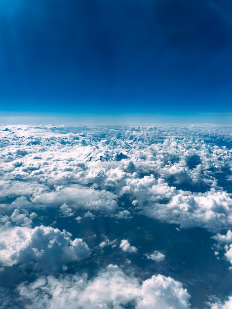 Aerial view of steep rocky snowcapped mountain range on beautiful sunny day