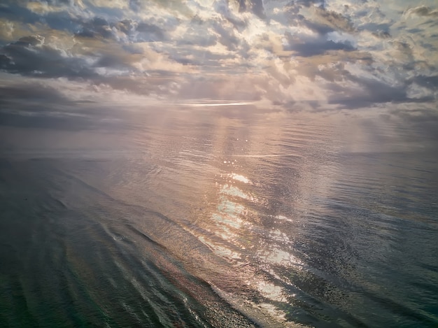 Aerial view of a Sunrise sky. Aerial Dramatic gold sunrise with morning sky clouds over the sea. Stunning sky clouds in the sunrise. Aerial photography.