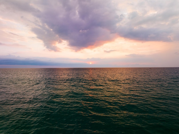 Aerial view sunset dark sky sea surface Nature Light Sunset or sunrise over sea Dark clouds sky with waves in sunset sky background