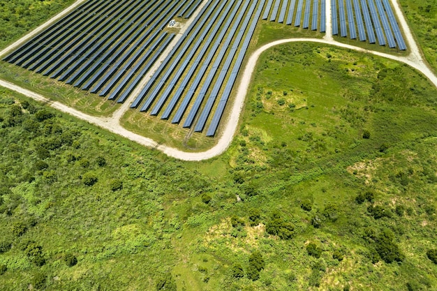 Aerial view of sustainable electrical power plant between agricultural farmlands with photovoltaic panels for producing clean electric energy Concept of renewable electricity with zero emission