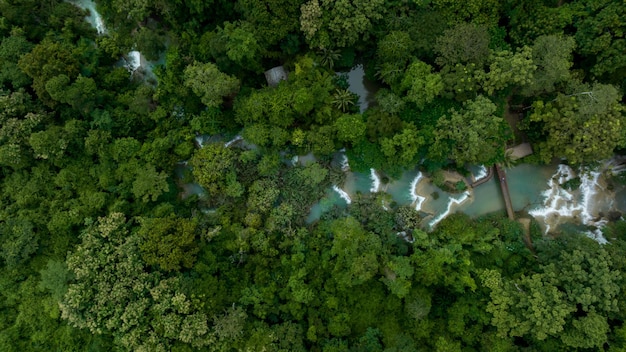 Aerial view Tat Kuang Si Waterfall in Luang Prabang Laos Beautiful waterfall in jungle tropical rainforest and wooden bridge at Tat Kuang Si Luang Prabang Laos