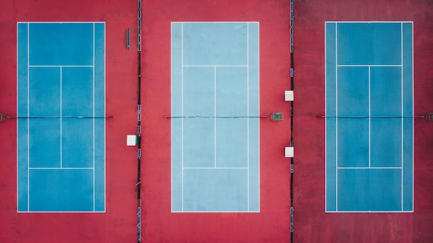 Aerial view of three empty tennis courts